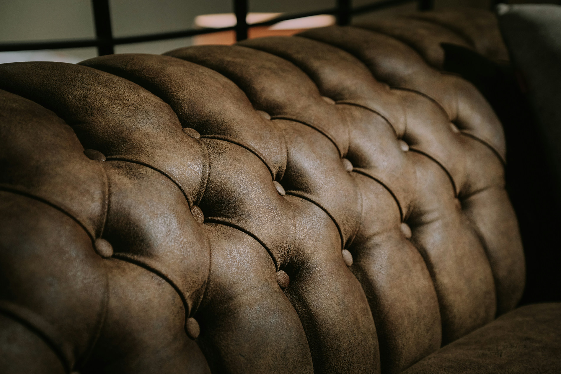 Tufted leather sofa, close detail of the hide and buttons